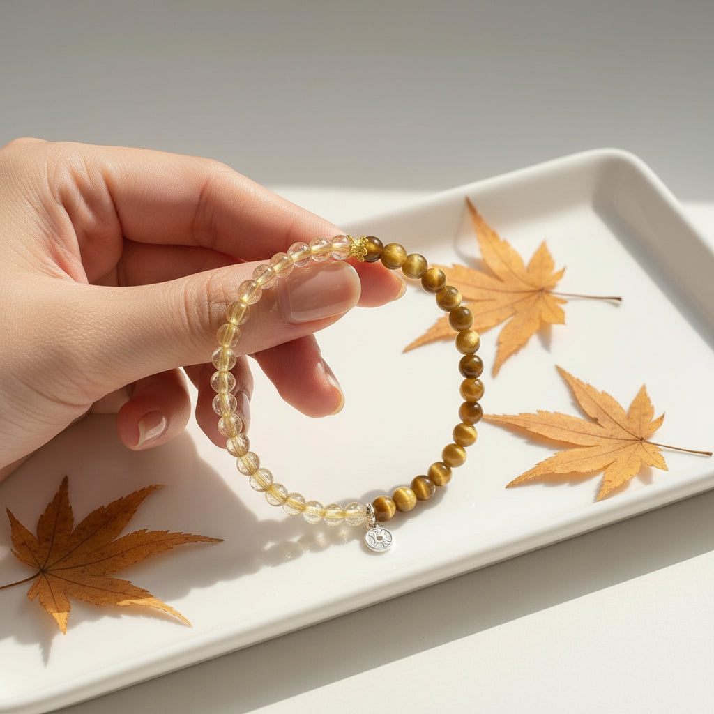 Beaded bracelet with a charm on a white background with autumn leaves