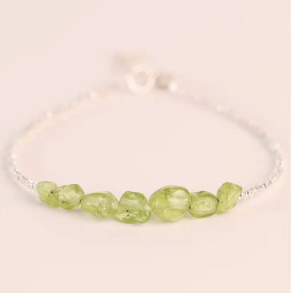 Bracelet with green beads on a light background