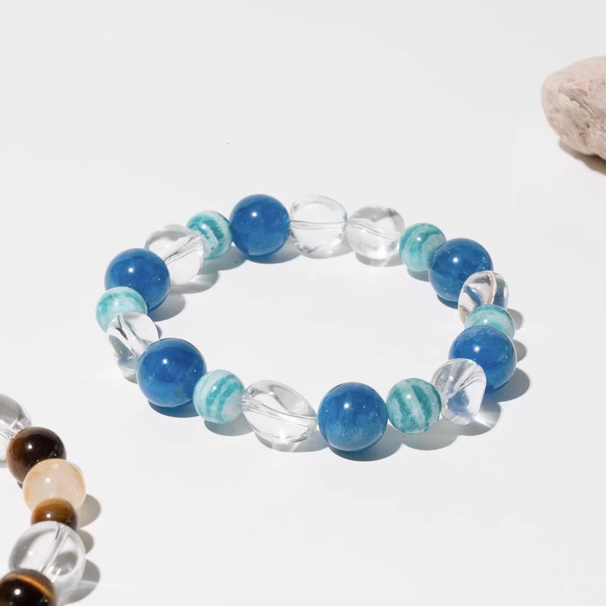 Beaded bracelet with blue, clear, and brown beads on a white background