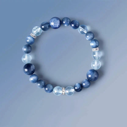 Blue beaded bracelet on a gray background