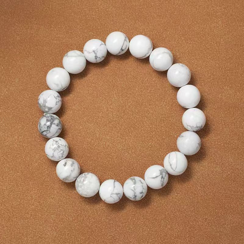 White marble beaded bracelet on a brown background