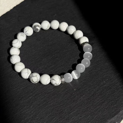 Beaded bracelet with silver accents on a dark surface