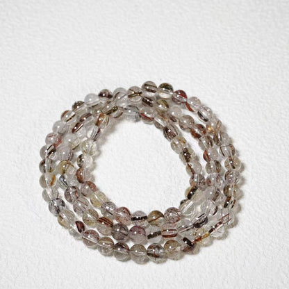 Stack of multicolored beaded bracelets on a white background