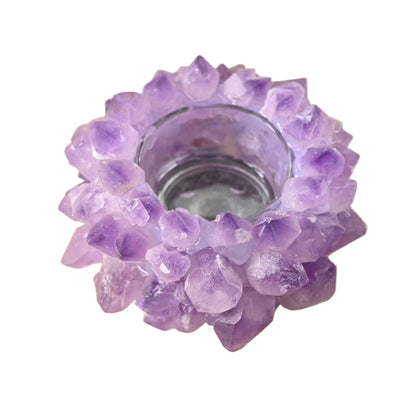 Purple crystal candle holder on a wooden surface