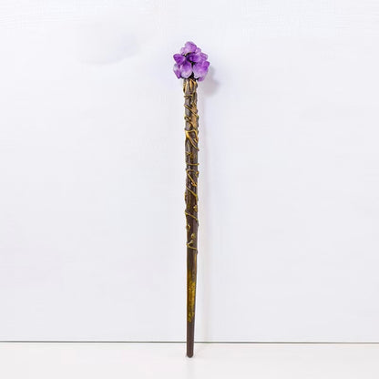 Decorative staff with purple gemstone on a white background