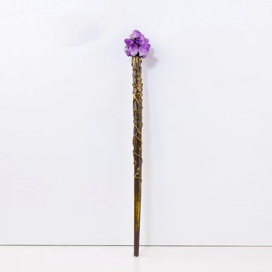 Decorative staff with purple gemstone on a white background