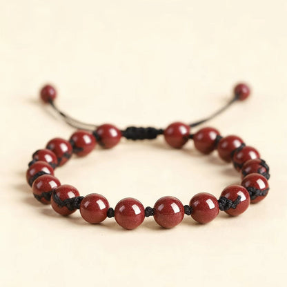 Red beaded bracelet on a beige background