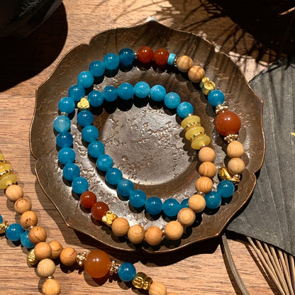 Beaded bracelets on a metallic dish with a natural background